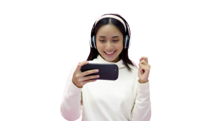 Asian women smiling and listening and singing the music with headphones on a pink studio background