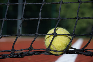 Tennis ball in the black net