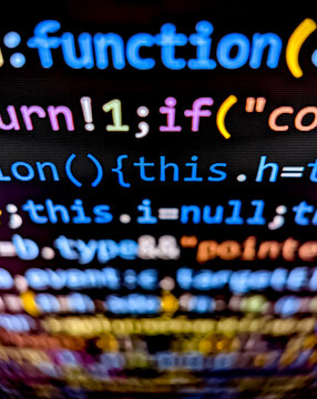 Closeup of lines of computer code function displayed on a digital screen with colorful letters and numbers in dark mode on black background