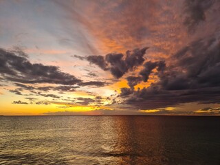 Light versus dark sunset over sea