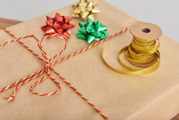 Decorative ribbons and bows on a wrapped Christmas present. Concept of preparing gifts for the holidays.