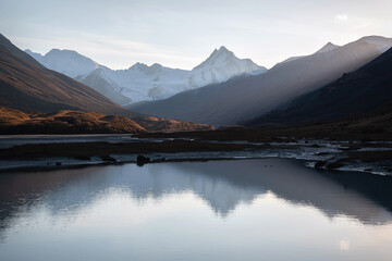 Fototapeta na wymiar mountains glacier lake reflection sunlight autumn