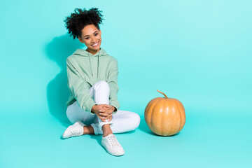Full length photo of sweet adorable girl dressed hoodie halloween preparations isolated teal color...