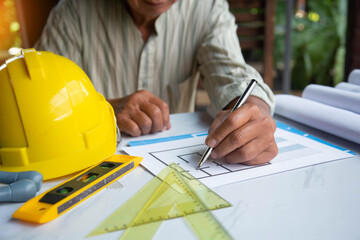 Architect designing project at Construction Site with blueprint