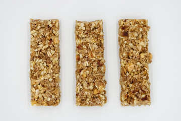 Cereal bar with apricot, apple and dried fruit on white background