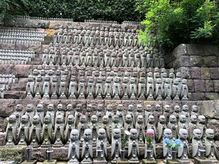 Rows of stone jizo statues in Hasedera temple garden in Kamakura