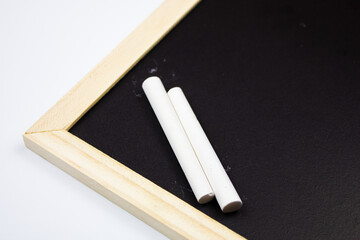 Chalk board and crayons on an isolated background.Wooden board for drawing or writing with chalk.