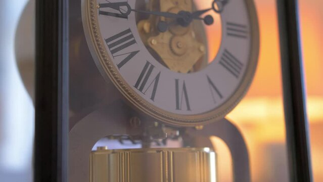 Vintage antique pendulum clock with roman numerals Close up 