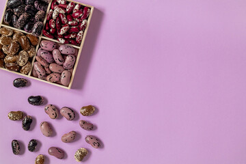 Wooden box with organic heirloom beans. Set of organic beans. Scarlet runner beans, anasazi beans. Top view. Copy space.