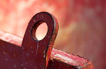a loop of red colored metal with a blurred background