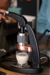 dirty coffee iced latte freeze milk pour espresso shot in a cup of coffee on scale measurement wooden bar table cafe in thailand asia by barista workout