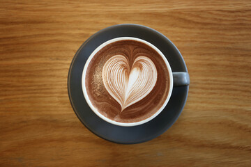 Latte art,Coffee mug placed on a table in a cafe.