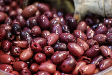 Black olives in an old wooden bowl