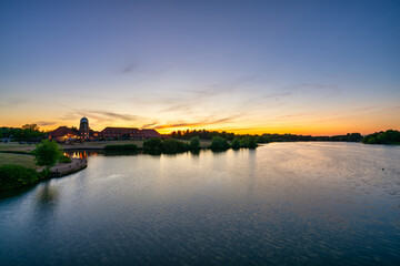 Fototapeta premium Old windmill on Caldecotte lake at sunset in Milton Keynes. England