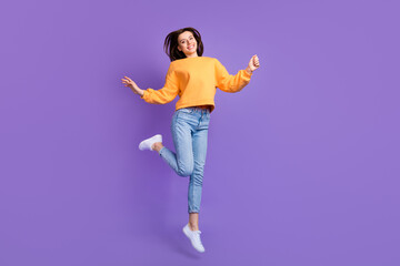 Fototapeta na wymiar Full body length photo of young attractive nice girl dancing celebrating trampoline jump hands up good mood isolated on purple color background