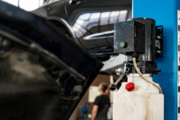 The electric lift for cars in the car repair service