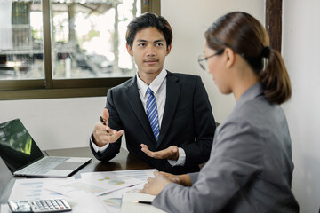 Two business leaders talk about charts, financial graphs showing results are analyzing and calculating planning strategies, business success building processes