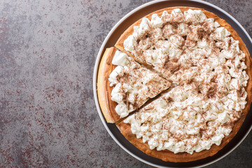 Rijstevlaai a rice pie, something that appears in Dutch and German cuisines close-up in a plate on the table. Horizontal top view from above