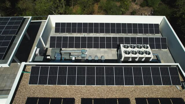 Air ventilation system and solar panels on a roof - high angle, tracking, aerial view