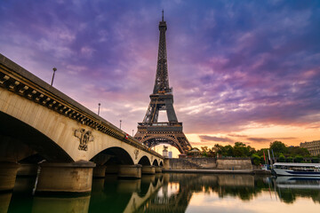 Fototapeta na wymiar Eiffel Tower by seine river at sunrise in Paris. France