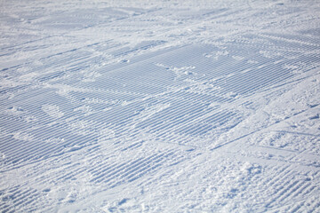 Snow on the ski run as background.