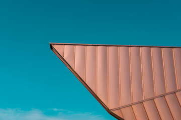 Architecture roofing detail. Cooper elevation panels in a dynamic shape. Modern architecture. Teal and orange. - Powered by Adobe