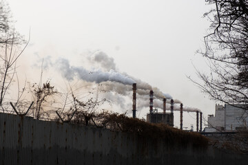 Smoke from the chimneys at the factory. Environmental pollution.