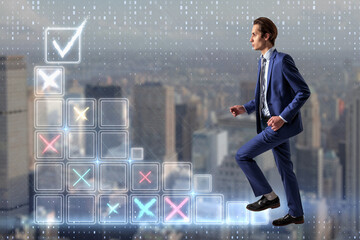 Plakat Attractive young european businessman climbing digital stairs to success on blurry city background. Futuristic goal achievement concept.
