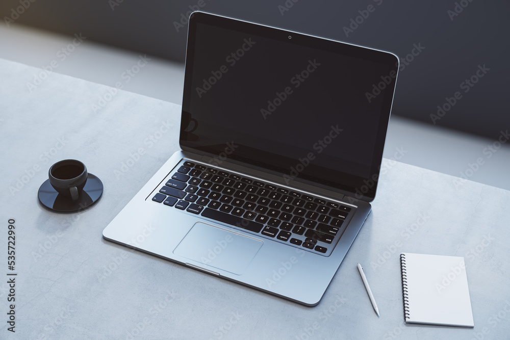 Poster close up of empty laptop on concrete desktop with coffee cup, notepad, pen, mock up place on screen,