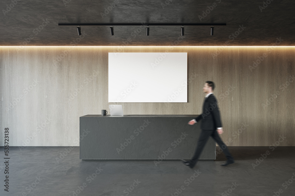 Aufkleber side view of young businessman walking in modern concrete and wooden office reception interior with 