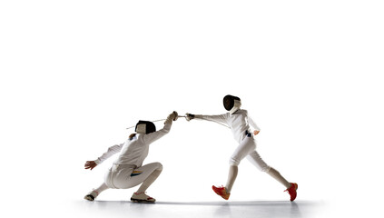 Two female fencing athletes fight isolated on white