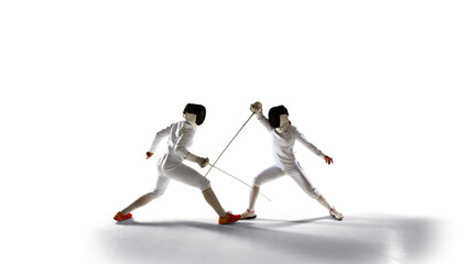 Two female fencing athletes fight isolated on white