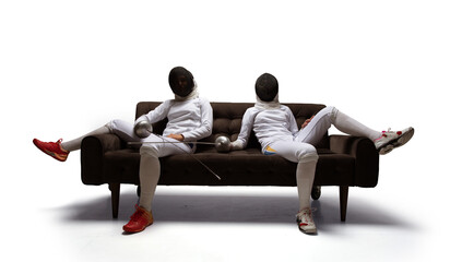 Obraz premium Two female fencing athletes fight isolated on white