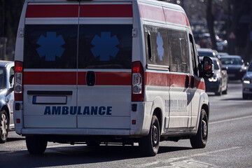 Paramedic 911 ambulance car running fast through the big city.