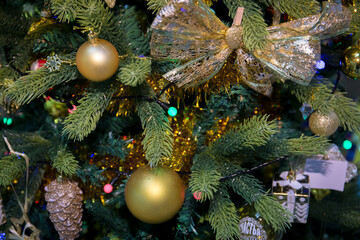 Christmas tree decorated with festive glass balls and garlands. Close up.