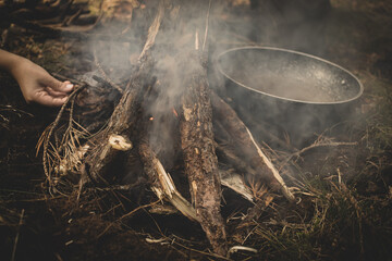 preparation of a pan, for cooking on a fire in the forest.