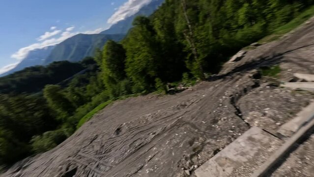 White sport car riding on asphalt serpentine road mountain valley summer sunny forest landscape aerial view. Automobile travel by empty roadway at alpine resort picturesque natural scenery panorama 4k