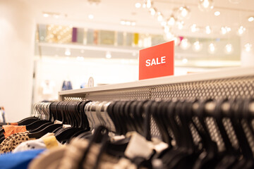 Close up clothes hangers on rack with anti theft alarm. Background for fashion retail shop shop and...