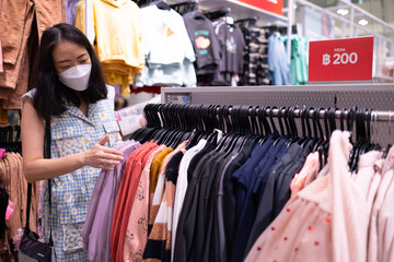 Close up clothes hangers on rack with anti theft alarm. Background for fashion retail shop shop and apparel store.