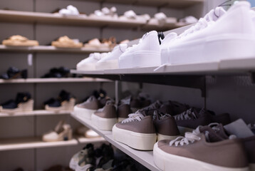 Close up clothes hangers on rack with anti theft alarm. Background for fashion retail shop shop and...