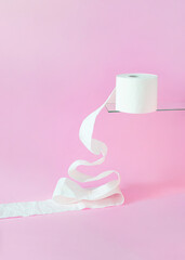 Christmas tree shape made of white toilet paper roll against bright pink background. Minimal concept art.