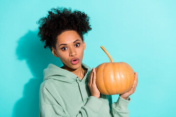 Photo of impressed person hands hold pumpkin pouted lips unbelievable isolated on shine turquoise...
