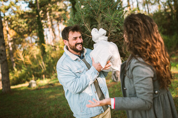 Naklejka premium Young happy couple is preparing for the New Year holidays