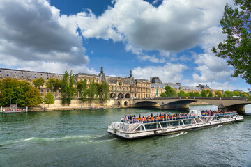 Beautiful scenery of Paris with ferry boat near Pont du Carrousel bridge. France