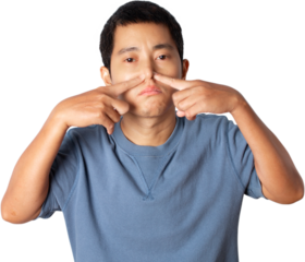 Portrait of young man pinching nose on his face due to bad smell.