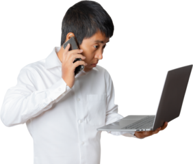 Portrait of businessman using laptop computer and smartphone.