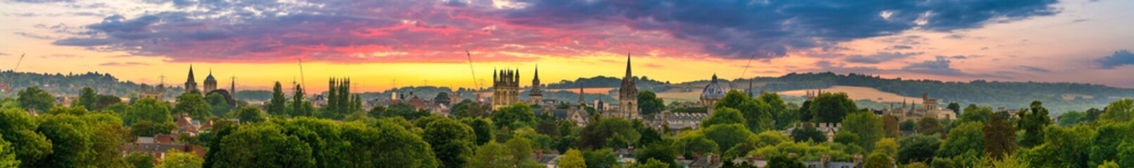 Skyline rooftop panorama of Oxford city at sunset. England