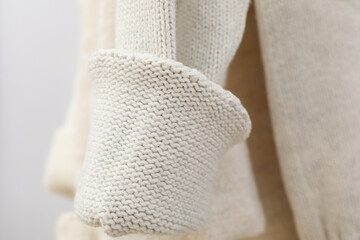 Hanging sweaters, concept of autumn season clothes