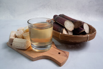 a glass of black sugar cane juice, can be used as a traditional medicine to relieve cough, fever,...