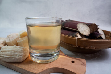 a glass of black sugar cane juice, can be used as a traditional medicine to relieve cough, fever,...